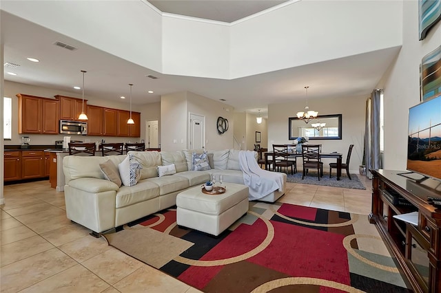 living room featuring light tile patterned floors, a chandelier, and a high ceiling