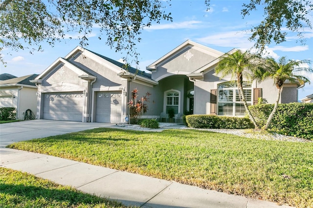 view of front of house with a front yard and a garage