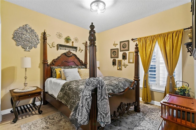 bedroom with hardwood / wood-style flooring and a textured ceiling