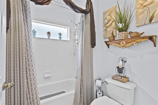 bathroom with toilet and shower / bath combo with shower curtain