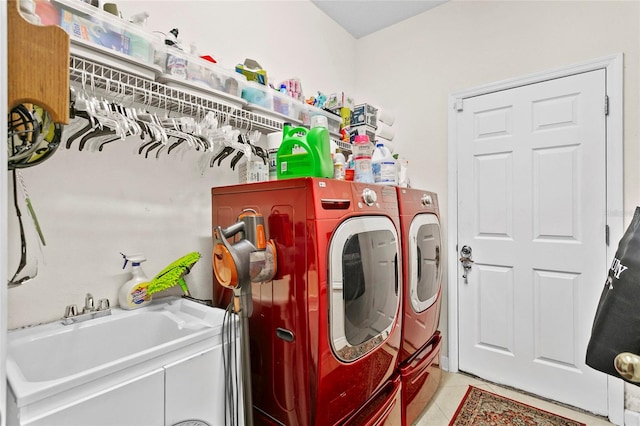 laundry room with washing machine and dryer, sink, and light tile patterned floors