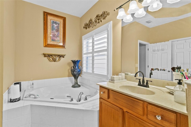 bathroom with vanity and a relaxing tiled tub