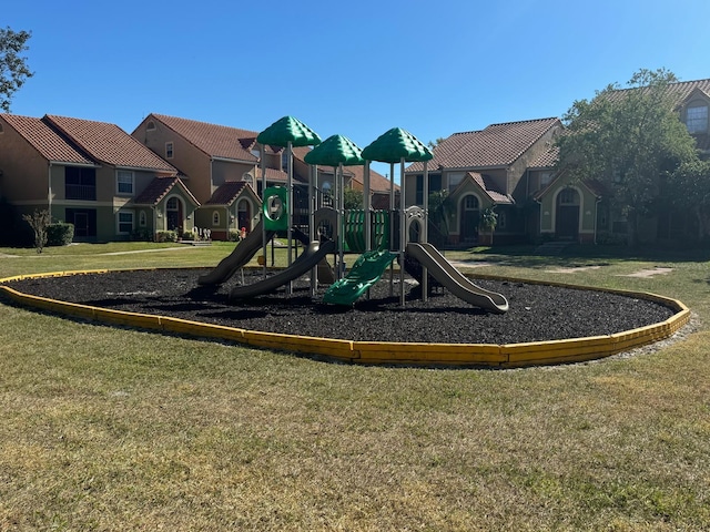 view of jungle gym featuring a lawn