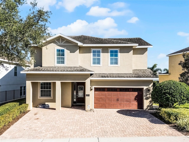 7639 Wilmington Loop, Kissimmee, FL 34747 - view of front of home featuring an attached garage, covered porch, decorative driveway, and stucco siding