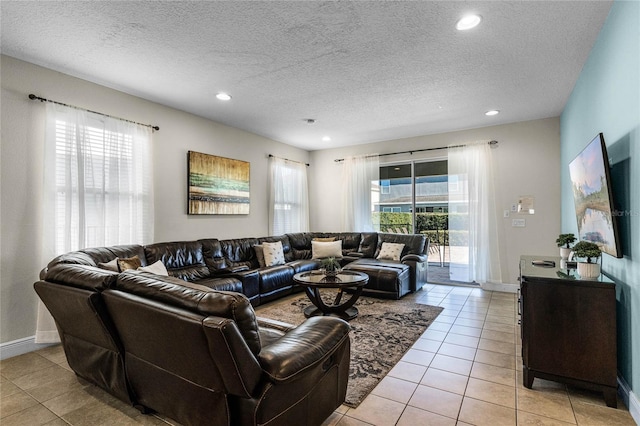 tiled living room featuring a textured ceiling and a wealth of natural light