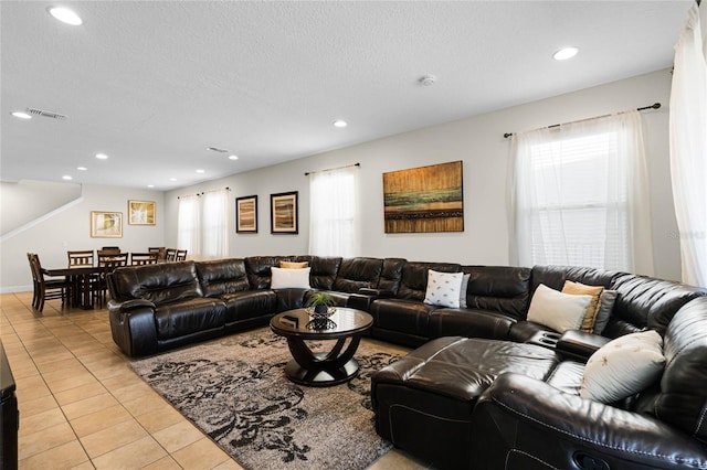 tiled living room with a textured ceiling