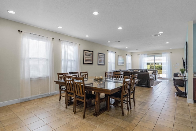 7639 Wilmington Loop, Kissimmee, FL 34747 - dining room featuring recessed lighting, a textured ceiling, and light tile patterned floors