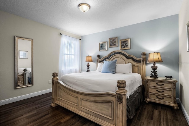 bedroom featuring dark wood-type flooring and a textured ceiling