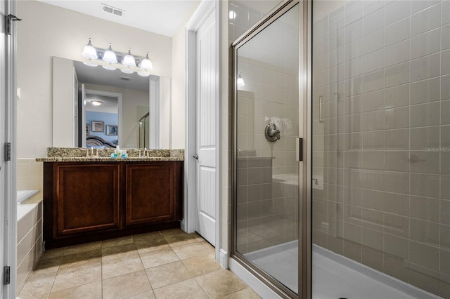 bathroom featuring tile patterned flooring, vanity, and an enclosed shower