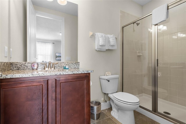 bathroom featuring toilet, vanity, tile patterned floors, and walk in shower