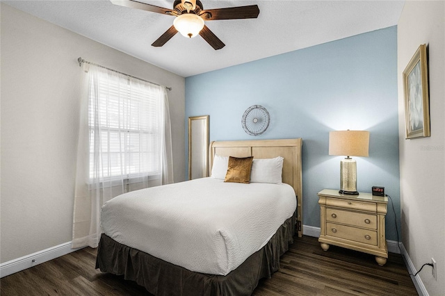 bedroom with ceiling fan and dark hardwood / wood-style flooring