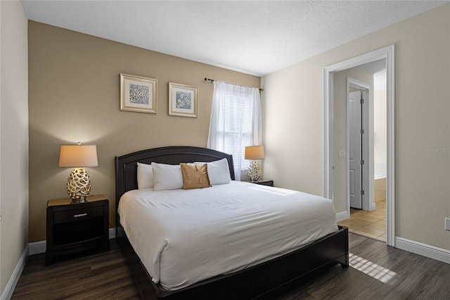 bedroom with dark wood-type flooring and a textured ceiling