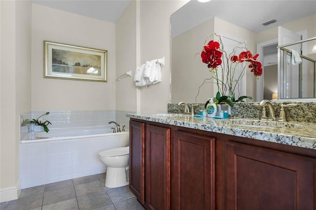 full bathroom with tile patterned floors, vanity, a textured ceiling, separate shower and tub, and toilet