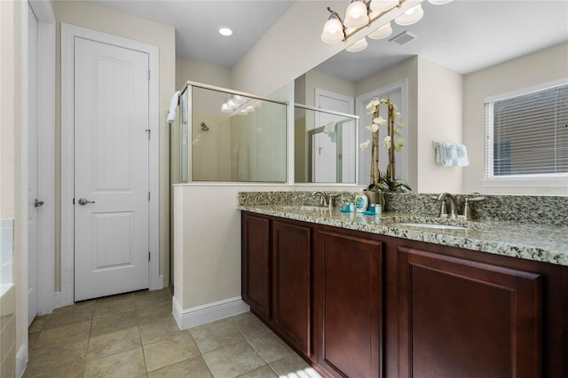 bathroom featuring vanity, tile patterned floors, and walk in shower