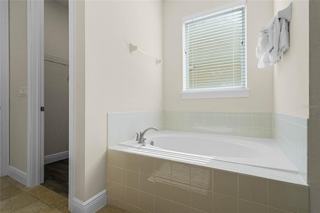 bathroom featuring tiled tub and tile patterned flooring