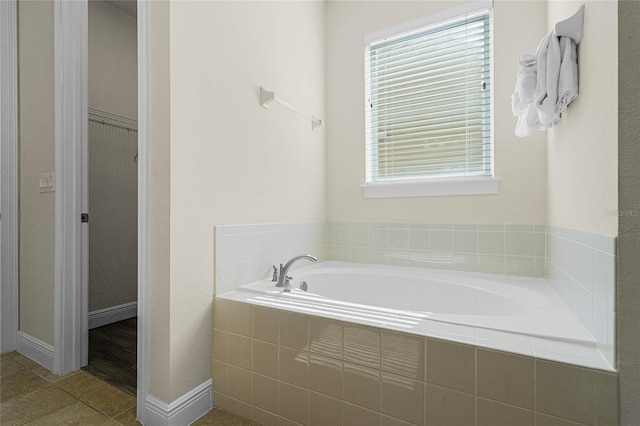 7639 Wilmington Loop, Kissimmee, FL 34747 - bathroom featuring a garden tub, plenty of natural light, tile patterned flooring, and a spacious closet