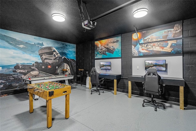 game room with a textured ceiling