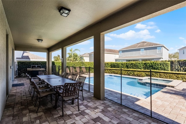 7639 Wilmington Loop, Kissimmee, FL 34747 - fenced backyard with a patio area, outdoor dining area, area for grilling, and a pool with connected hot tub