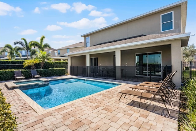 view of swimming pool with an in ground hot tub and a patio area