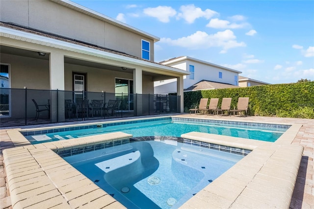 view of pool with an in ground hot tub and a patio