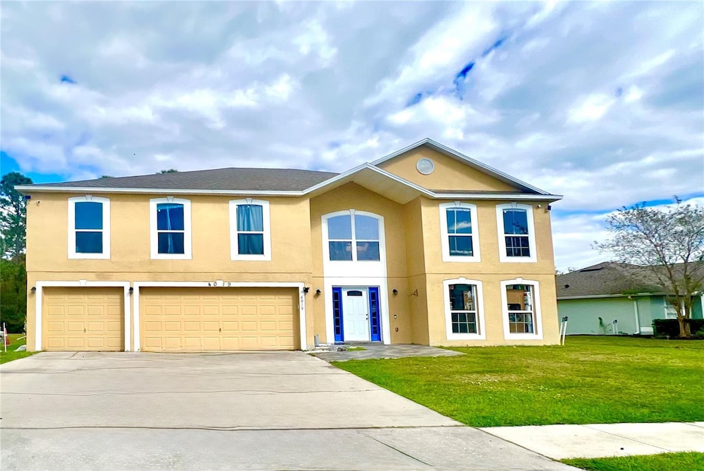 view of front of house featuring a front yard and a garage