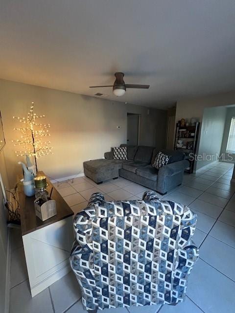 living room with tile patterned floors and ceiling fan