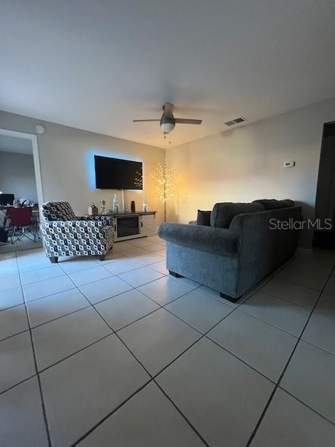 living room featuring light tile patterned floors and ceiling fan