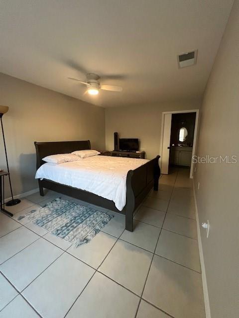 tiled bedroom with ceiling fan