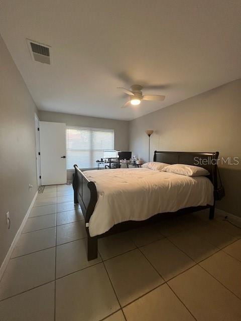 bedroom with ceiling fan and light tile patterned floors