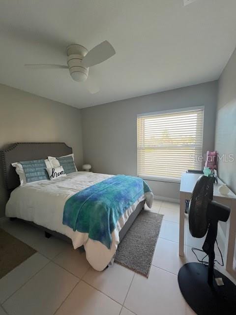 tiled bedroom with ceiling fan