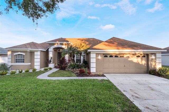 ranch-style house featuring a front yard and a garage