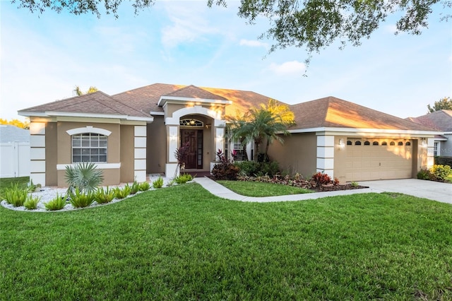 view of front facade with a garage and a front yard