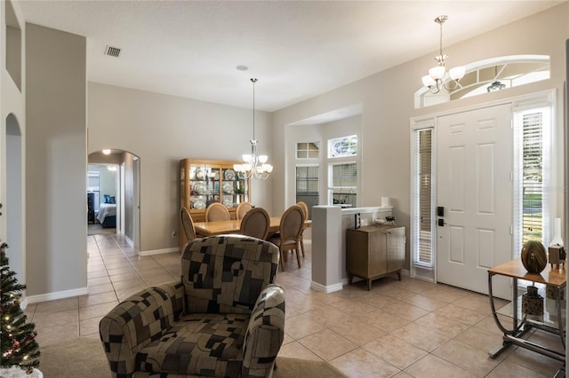 foyer featuring light tile patterned floors and an inviting chandelier