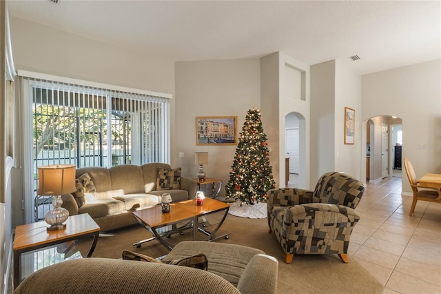 tiled living room with a towering ceiling