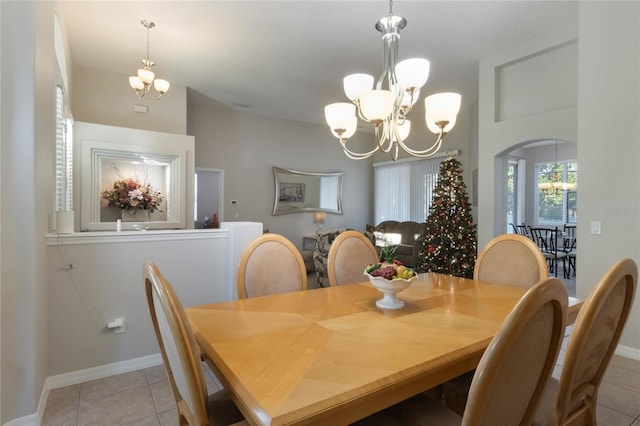 tiled dining room featuring a notable chandelier