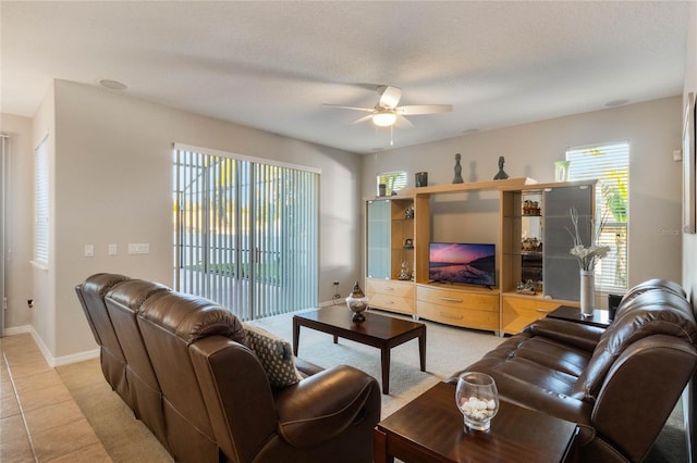 tiled living room with ceiling fan and a textured ceiling