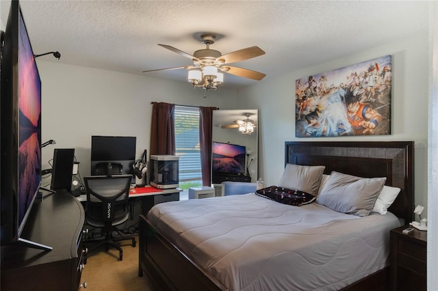 carpeted bedroom featuring a textured ceiling and ceiling fan