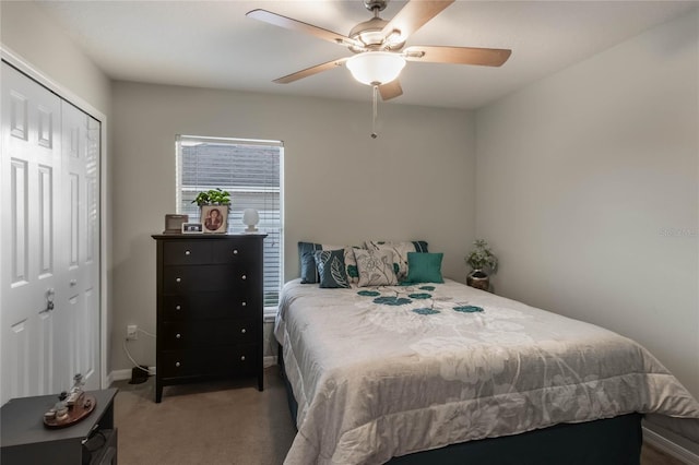 carpeted bedroom featuring ceiling fan and a closet