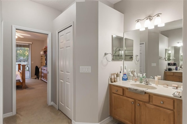 bathroom with ceiling fan and vanity