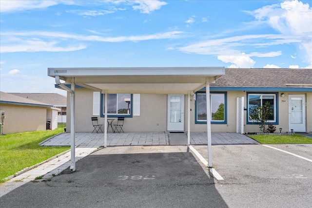 392 Winter Ridge Blvd Unit 105, Winter Haven, FL 33881 - view of front of house with a front lawn, uncovered parking, and stucco siding