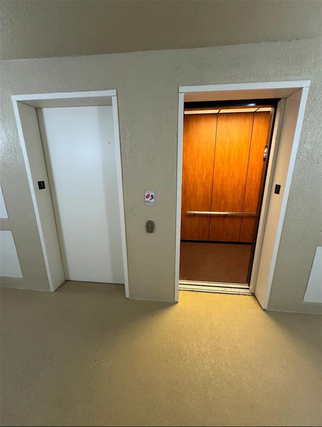 interior space featuring elevator and a closet