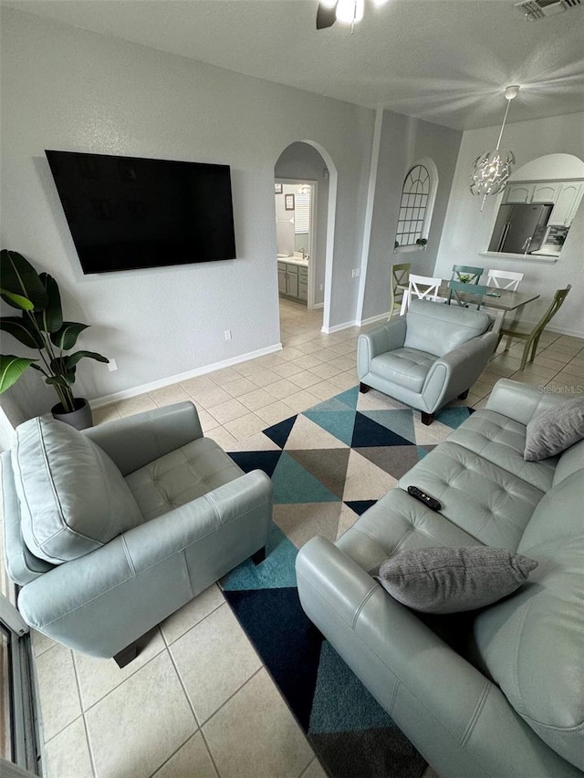 tiled living room with a chandelier