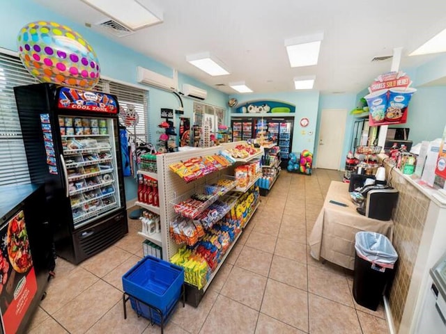 playroom with a wall unit AC and light tile patterned flooring