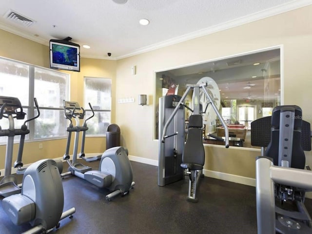 exercise room featuring crown molding and a textured ceiling