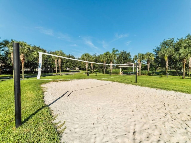 view of community featuring volleyball court and a yard