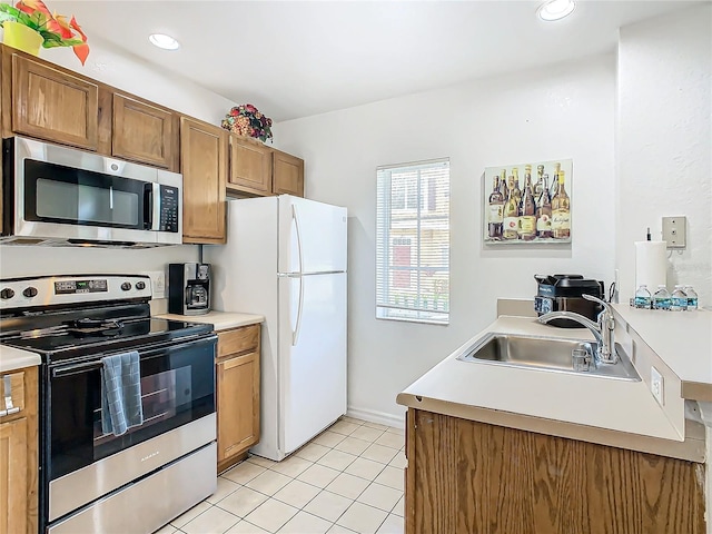 kitchen with sink, light tile patterned flooring, and appliances with stainless steel finishes