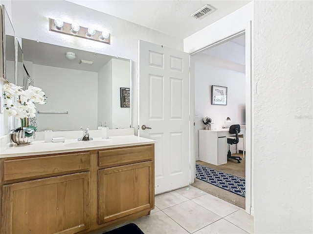 bathroom featuring tile patterned floors and vanity