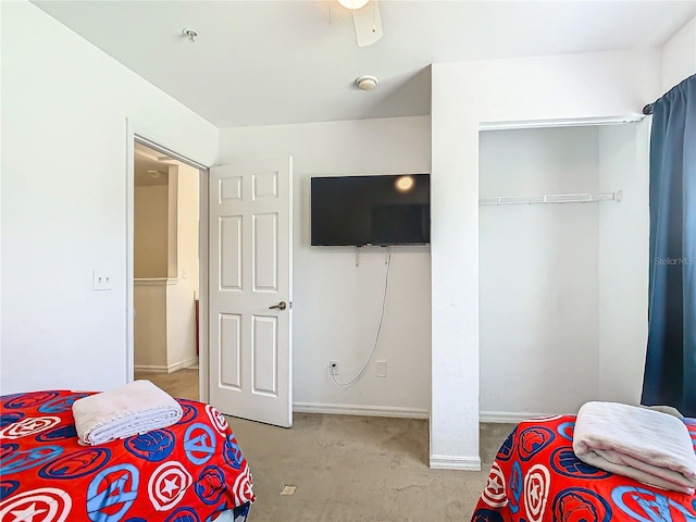 bedroom featuring ceiling fan, light colored carpet, and a closet