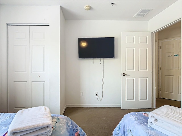 carpeted bedroom with a closet