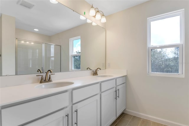 bathroom featuring vanity and a shower with door